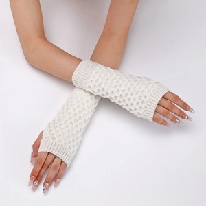 Close-up of white knitted arm warmer with diamond pattern worn by a model