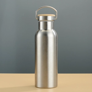 Close-up of stainless steel water bottle featuring a bamboo lid and metal handle