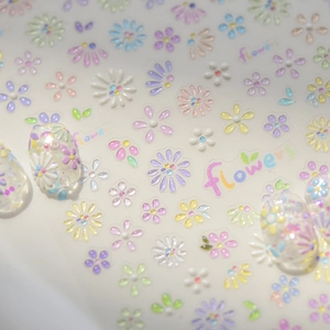 Macro detail of 3D pastel flower nail stickers with sparkling rhinestones and floral art