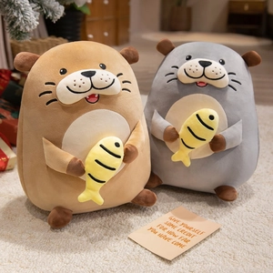 Cute otter plush dolls holding small yellow fish in brown and grey soft textures