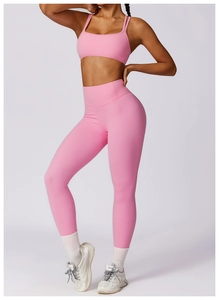 Detailed view of pink high-waist yoga leggings and double-strap sports bra set
