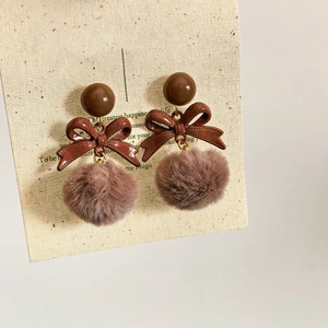 Retro brown bowknot plush ball earrings featuring silver pins and a velvet texture finish