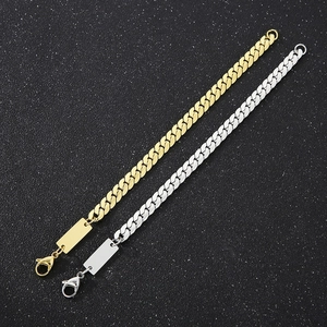 Detailed view of gold and silver Cuban link chains with rectangular ID tags for engraving