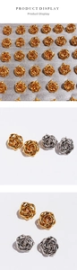 Macro shot of abstract irregular spiral rose flower stud earrings in gold and silver