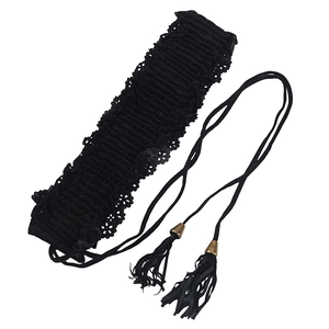 Black elastic corset belt with delicate lace trim and fringed tassel ties on white background