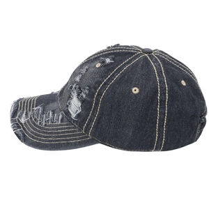 Close-up of distressed washed denim baseball cap with frayed holes and contrast stitching