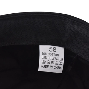 Detail view of the black military hat inner lining with material care label and size 58 tag