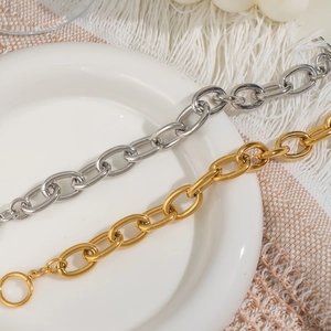 Luxurious 18K gold and silver stainless steel OT buckle chain bracelet on ceramic plate