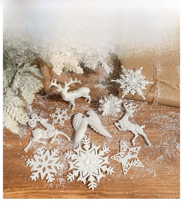 Detailed close-up of white glittery Christmas ornaments on a rustic wooden table background