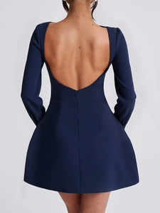 Back view of elegant dark blue long sleeve mini dress featuring a wide open back design