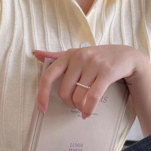 Close-up of minimalist 925 silver beaded open ring on a model with lifestyle background