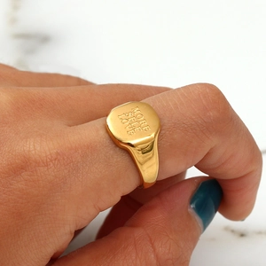Macro shot of 18K gold plated ring featuring 'MORE SELF LOVE' engraving on a square face