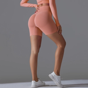 Detail of peach orange seamless high waist yoga shorts showing butt lifting knit texture