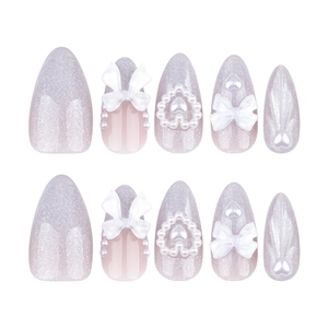 Faux ongles amande faits main avec nœuds 3D, perles et dégradé de paillettes violettes