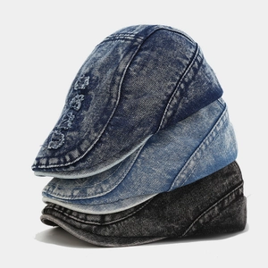 Close-up of washed denim ivy caps in dark blue, light blue, and grey with distressed details