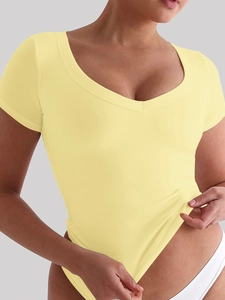 Close-up of pale yellow V-neck short sleeve bodysuit with soft stretch fabric fit