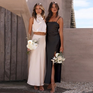 Detailed view of elegant satin slip dress with a stylish side slit in black and champagne