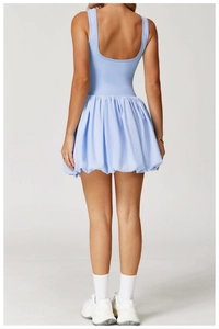Back view of light blue athletic bubble skirt dress featuring a minimalist open back design