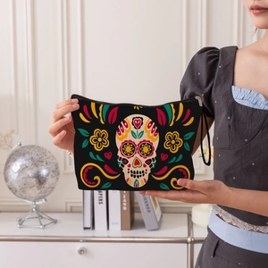 Black cosmetic bag with colorful Mexican sugar skull print and black wrist strap handle