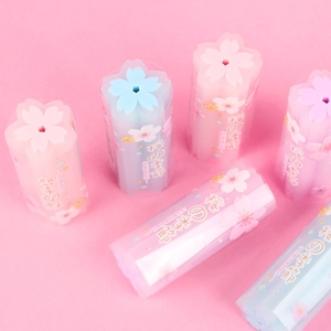 Cylindrical cherry blossom erasers in pastel pink, blue and purple on a soft background
