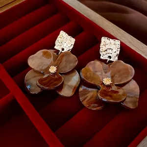 Retro flower earrings with gold metal and brown marble resin on a red velvet jewelry box
