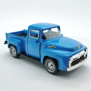 Detailed close-up of a blue vintage toy pickup truck with chrome accents on white background