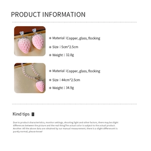 Detailed view of pink flocked strawberry earrings and necklace with copper and crystal