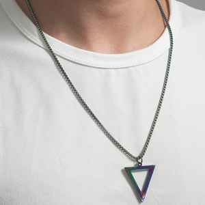 Close-up of a model wearing a rainbow-colored triangle pendant on a matching bead chain