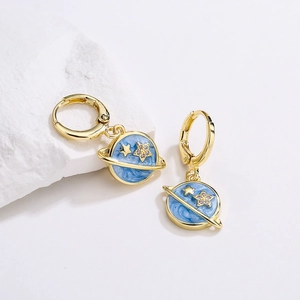 Gold plated planet earrings with blue enamel and cubic zirconia on white stone