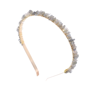 Close-up of handmade gold metal headband with wrapped grey-blue natural stone chips