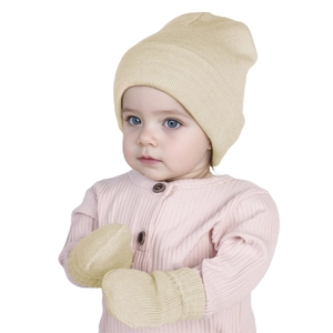 Detail of baby knitted beanie and mittens set in beige soft fabric for winter