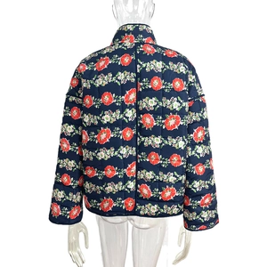 Rear view of navy blue quilted cotton jacket with red floral pattern and stand collar