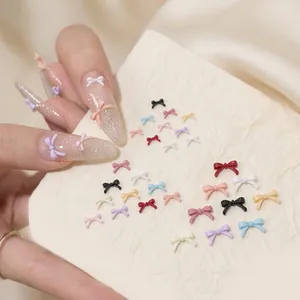 Detailed view of colorful 3D resin heart and bow charms for DIY nail art decoration
