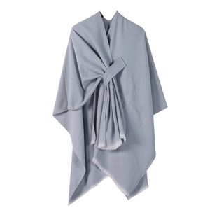 Detailed view of the gray-blue cashmere-like shawl featuring elegant tassel fringe edges