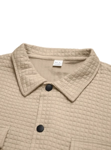 Detailed macro view of the khaki quilted jacket collar with L size tag and premium fabric texture
