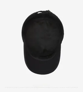 Internal view of the black flat top cap showing the adjustable metal buckle and strap
