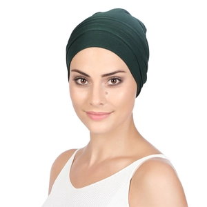 Detailed close-up of dark green pleated turban hat for women in soft elastic fabric
