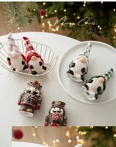 Festive ceramic Christmas gnome and nutcracker figurines on a cozy table setting