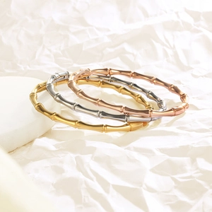 Three-tone stainless steel bamboo style bracelets in gold, silver, and rose gold finish