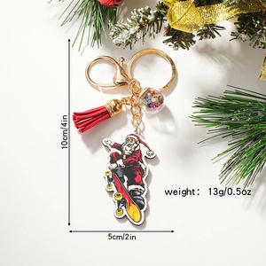 Cartoon Santa Claus on skateboard keychain with red tassel and starry ball gift