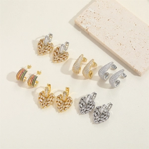 Detailed flat lay of cubic zirconia heart and teardrop earrings in gold and silver plating