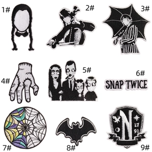 Detailed set of Wednesday Addams embroidery patches featuring Thing and academy logos