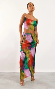 Detail of colorful gradient pleated fabric texture on a two-piece top and skirt set