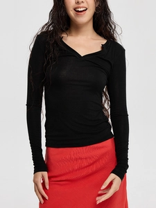 Slim fit black V-neck ribbed knit long sleeve top paired with red skirt for women