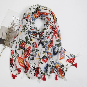 Detail of vintage floral cotton linen scarf with red tassels and nature patterns