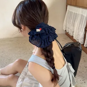 Navy blue polka dot chiffon scrunchie with handmade label and red heart charm