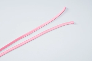 Close-up of pink elastic knitted fabric with detailed stitching and tie-up strap details