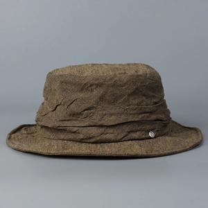 Detailed view of premium distressed linen bucket hat featuring a textured finish