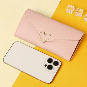 Detailed comparison showing long pink envelope wallet size next to a smartphone
