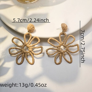 Detail view of woven raffia flower earrings showing sizes 5.7x7cm and 13g weight